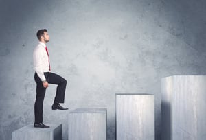 Business person stepping up a staircase