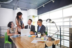 team of successful business people having a meeting in executive sunlit office